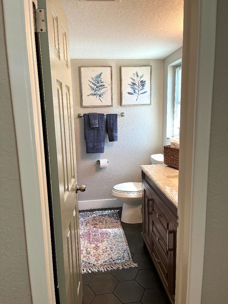 The bathroom is located right off of the bedroom. The perfect touch of cozy and chic. 