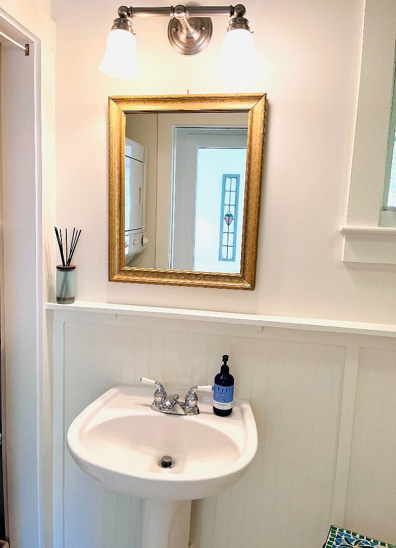 Bathroom with stackable laundry unit.