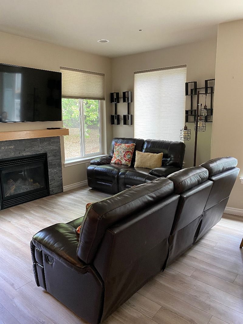 Gas fireplace, smart tv, couches incline, plenty of natural lighting.