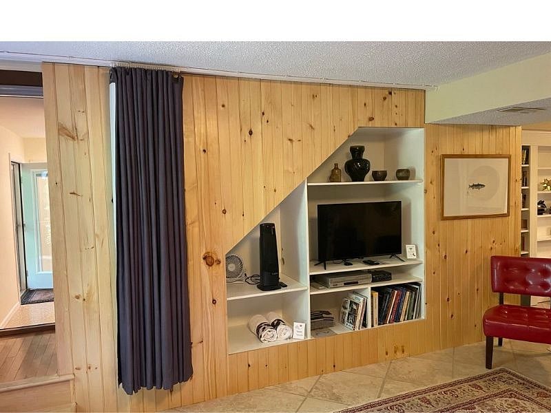 Pull the drape across the TV wall for extra privacy. Entry to unit is to the left in this image.