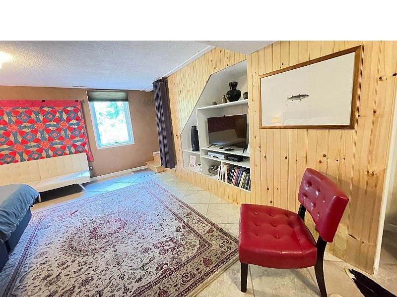 Nicely decorated TV wall in front of king bed.