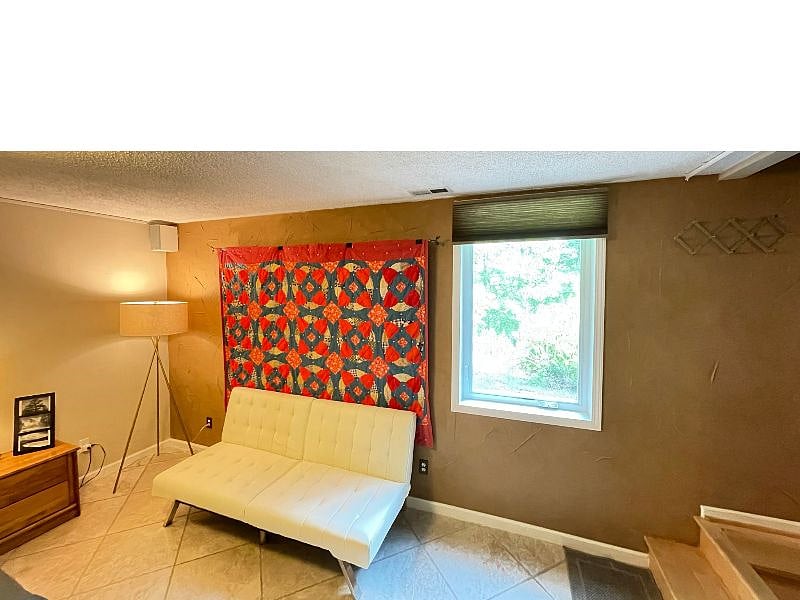 A large window offer a garden view out to a grassy area for you to enjoy.