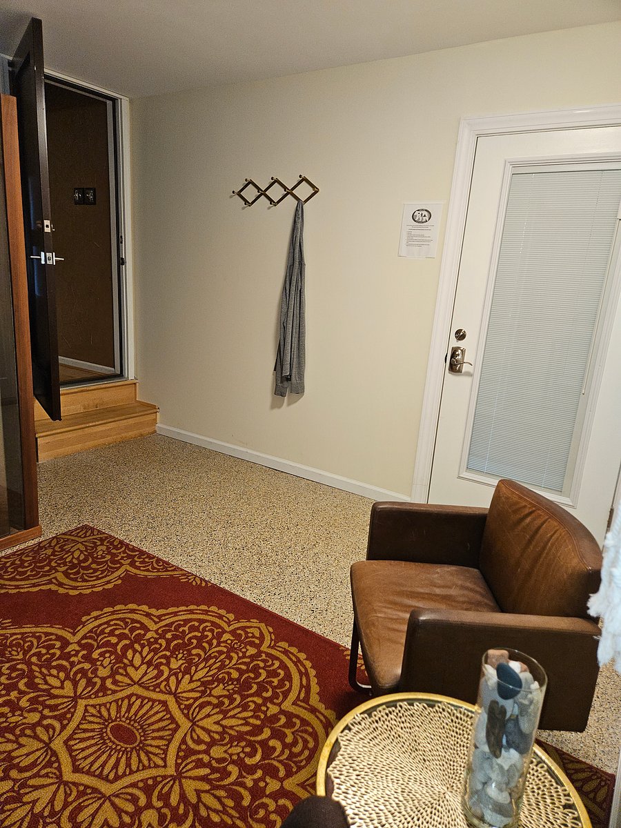 Private entry from exterior into office/sauna room. The interior door to this room is pictured. This door leads to the remaining suite.