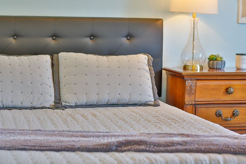 Relaxing after a days work in bedroom #2 with a queen bed and modern furnishing.