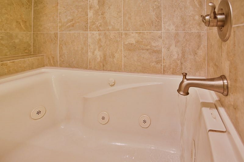 Private bathroom for bedroom #1 with premium jetted tub and shower combo!