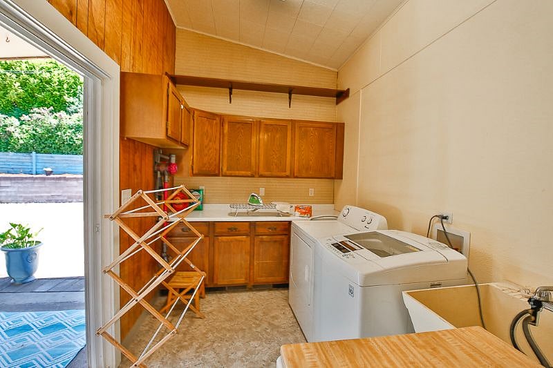 Fully stocked laundry room with washer and dryer.