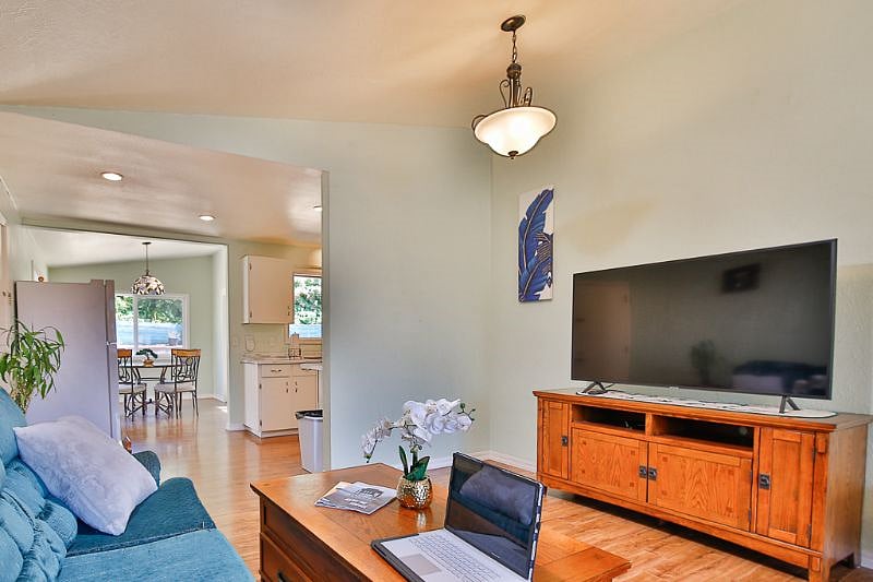 Living room with large screen smart TV and open concept!