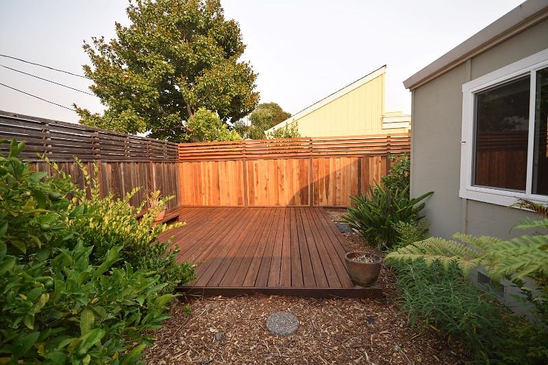 One of two spacious backyard deck. Other deck has firepit table and four chairs. 