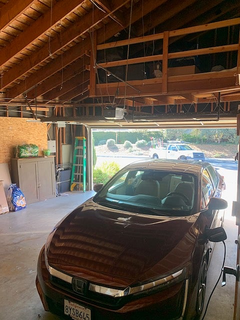 Large two-car garage with outlets for car plug ins and large storage loft.