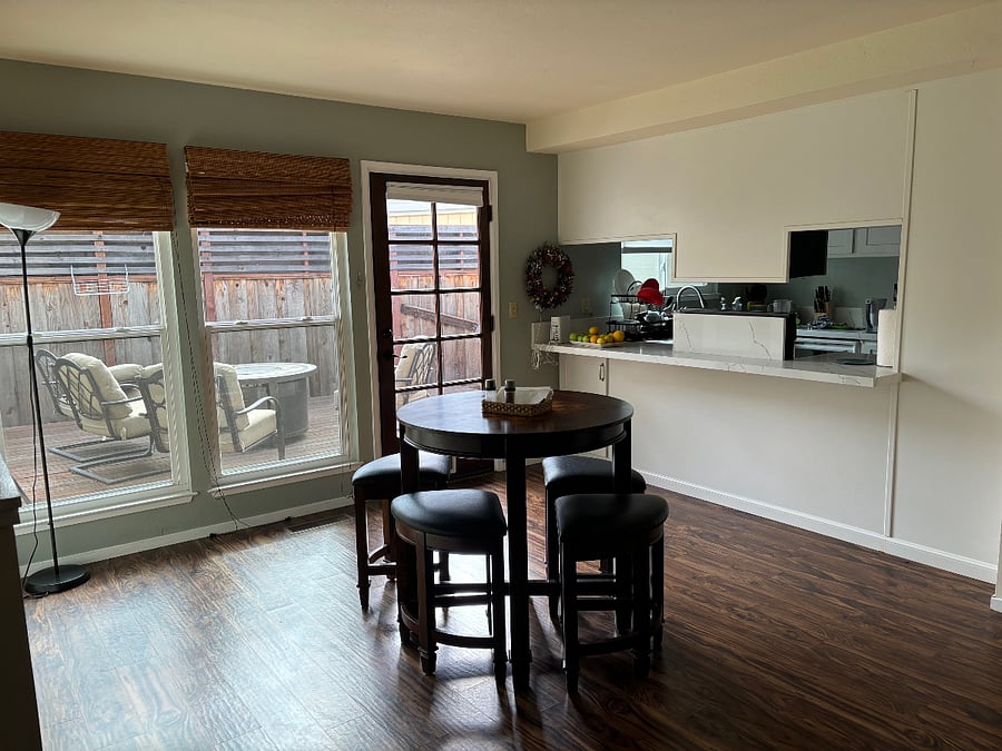 Family room off kitchen has high-boy game table with chess and checkers. Room opens to deck with firepit table.