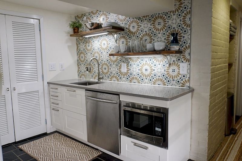 Kitchen includes full-size refrigerator, microwave/convection oven, large toaster oven, 2-burner portable cooktop, full-size dishwasher, and Keurig
