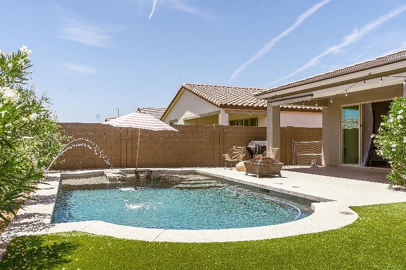 Yard with Pool and area with artificial grass.