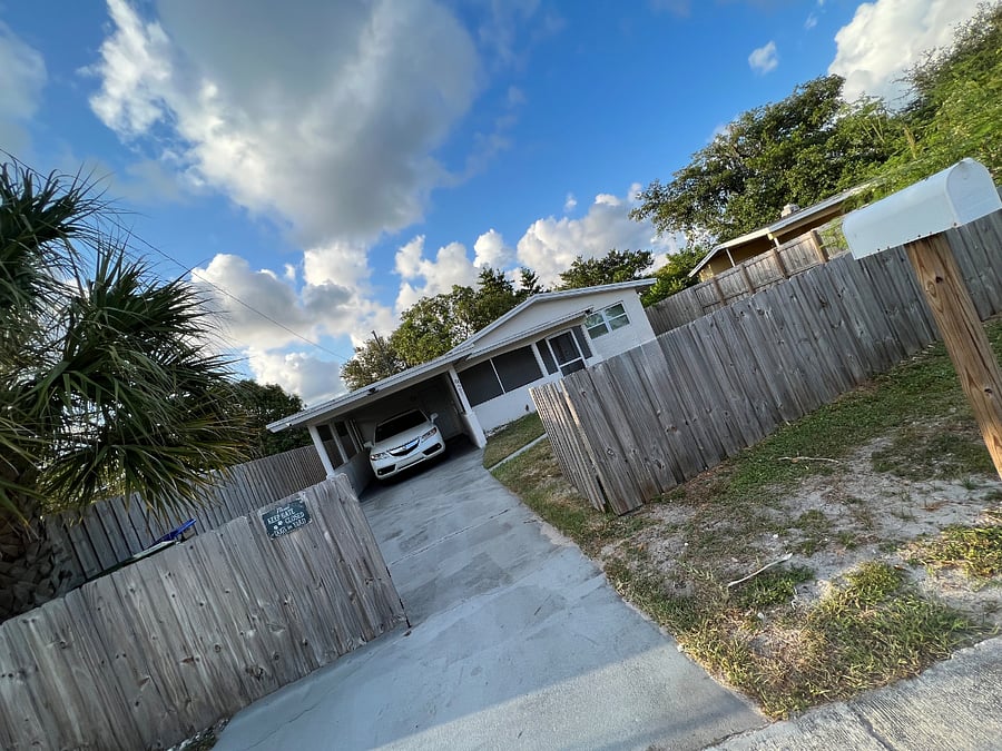 Front yard view with one gate opened