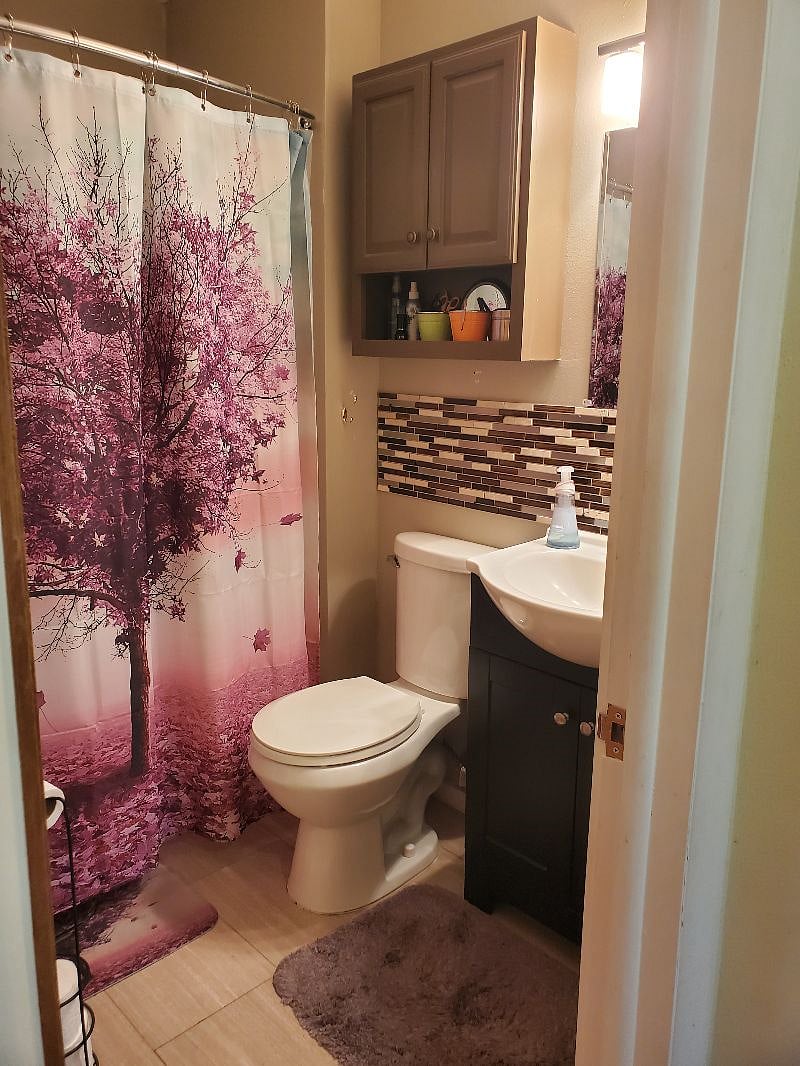 The bathroom has good water flow in the shower and shelves for your belongings.
