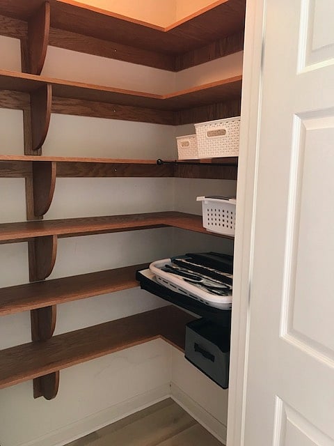 Shelving for storage and clothing. Furnished laundry basket and a couple of storage bins.