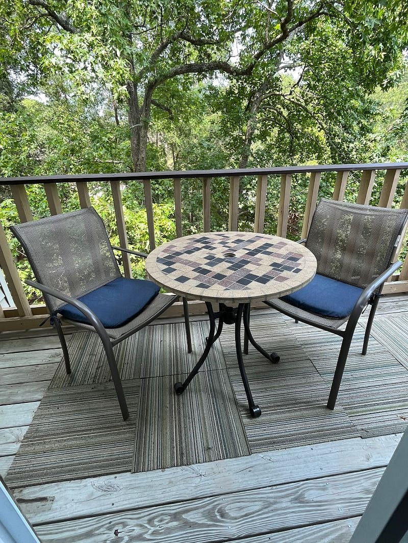 Deck with table and chairs overlooking the canal.