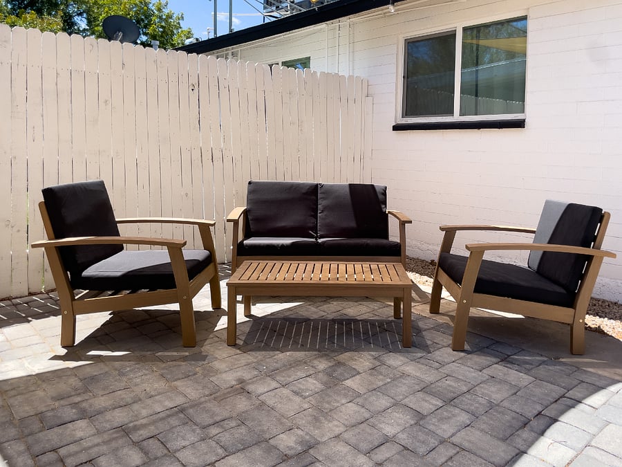 Private fenced back yard with patio furniture