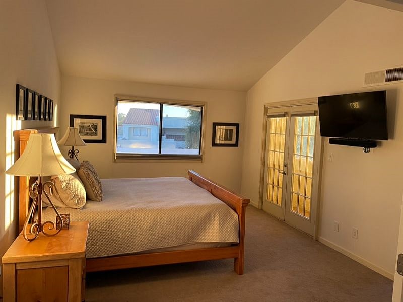 Primary Bedroom with mounted TV
