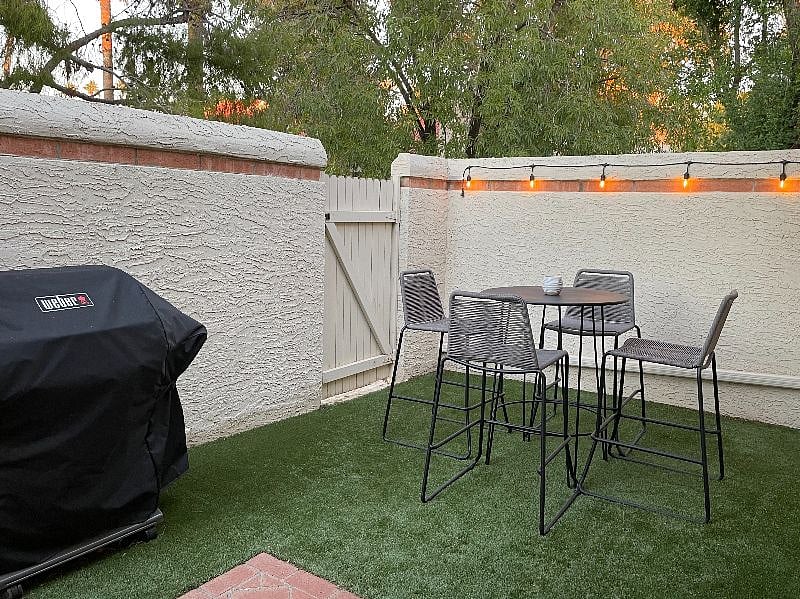 Enclosed backyard with BBQ and high top seating for private outdoor dining - with gate to community common area greenway