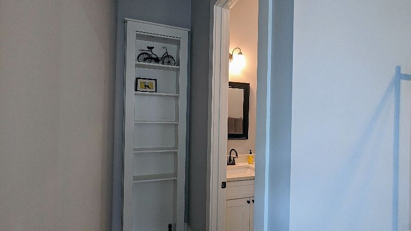 Additional built in bookselves near bathroom.
