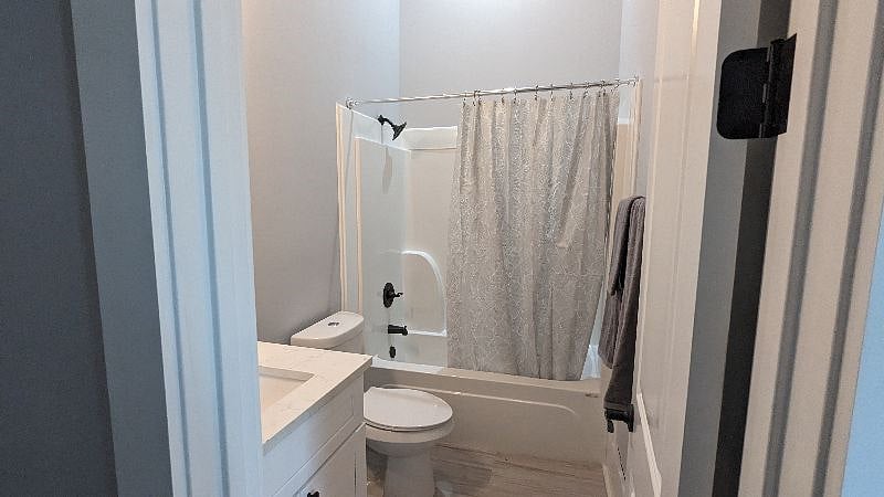 Bathroom includes towels, hairdryer, and storage.