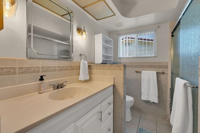 Guest bathroom with glass shower. Baby bathtub located in closet!