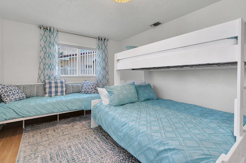 Queen bottom bed, Twin XL top bunk, and a twin daybed. Also a large bureau in the oversized closet!