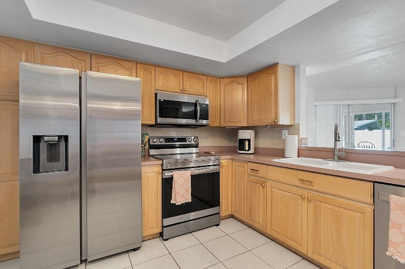 Wide, spacious kitchen with brand new appliances and fully stocked with all you need to make meals! Extra FULL SIZE fridge in the garage!