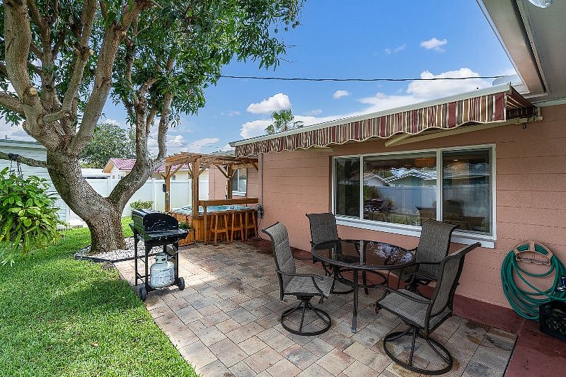 FULLY FENCED in, private back yard with Hot tub, grill + table!