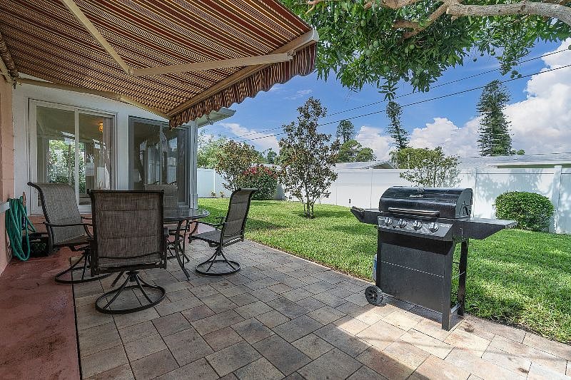 FULLY FENCED in, private back yard with Hot tub, grill + table!