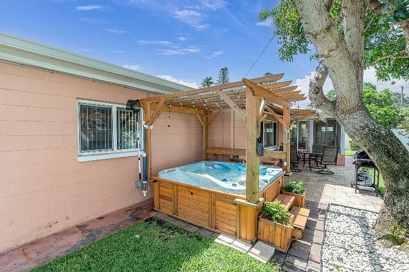 FULLY FENCED in, private back yard with Hot tub, grill + table!