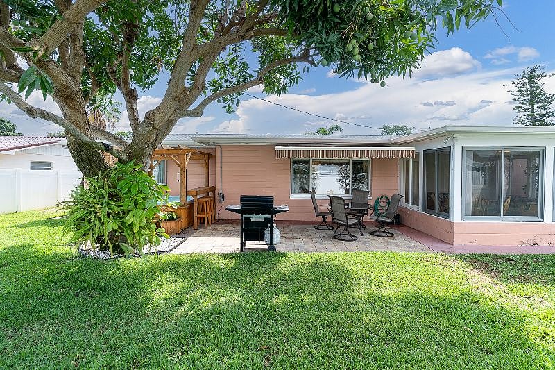 FULLY FENCED in, private back yard with Hot tub, grill + table!