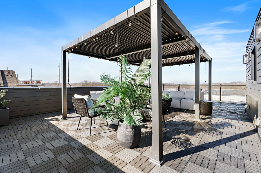Furnished rooftop terrace with louvered pergola and fire table