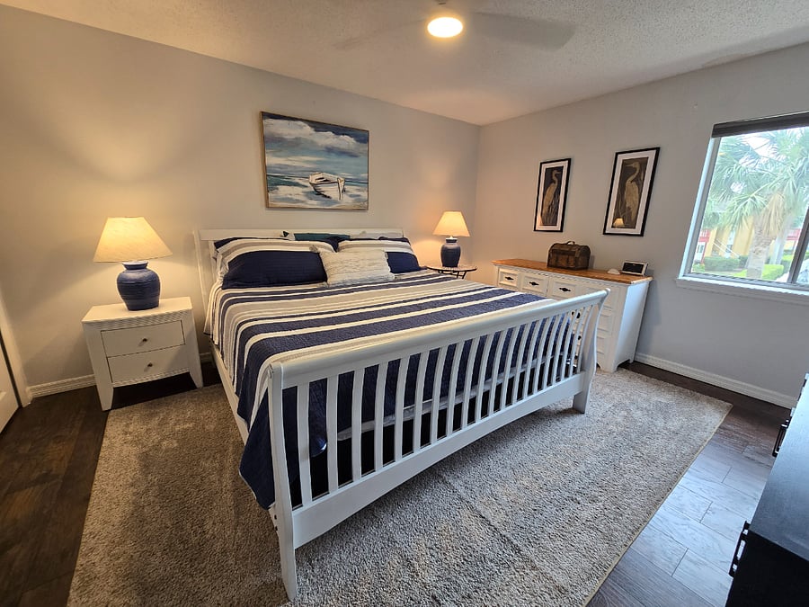 Master Bedroom King size bed with premium bedding. Pool views
