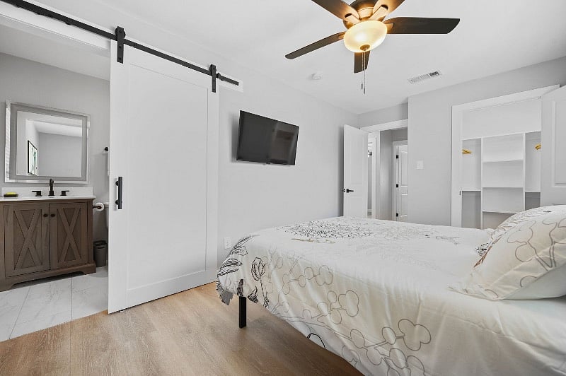 flat screen TVs in both primary and secondary bedrooms