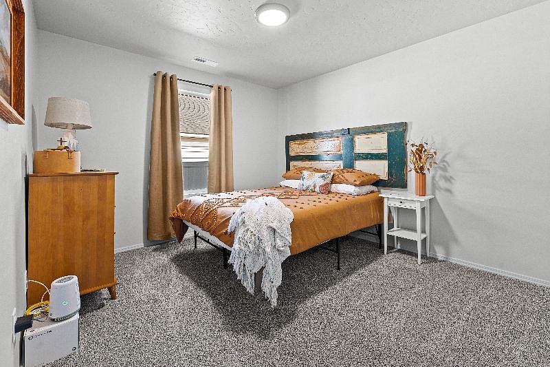 Guest room offers a cozy queen bed with upgraded linens, spacious dresser, large closet, oscillating fan, black out curtains and additional cozy amenities