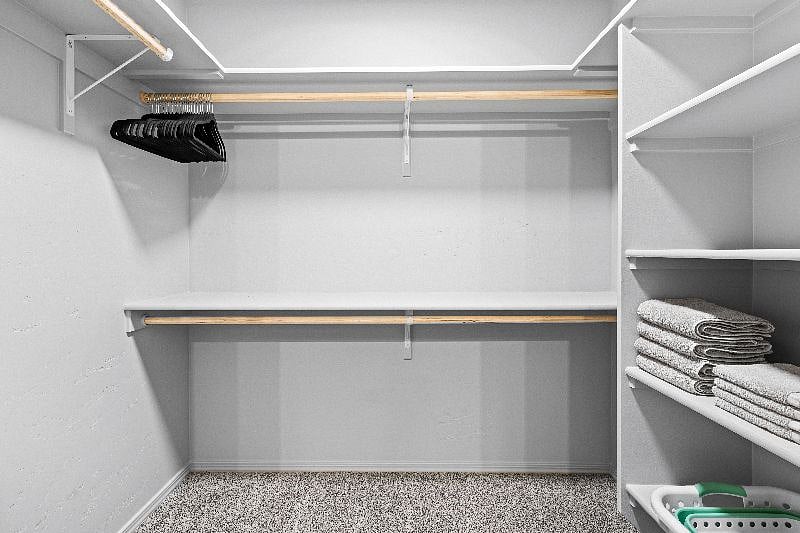 Large walk-in master closet, includes lots of hangers, shelves, laundry basket and oscilating fan for your use