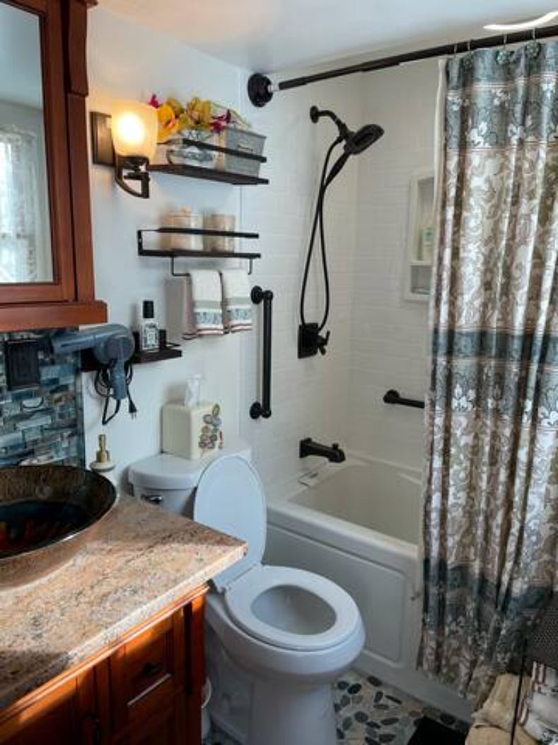 Renovated bathroom with rain shower and soaker tub.
