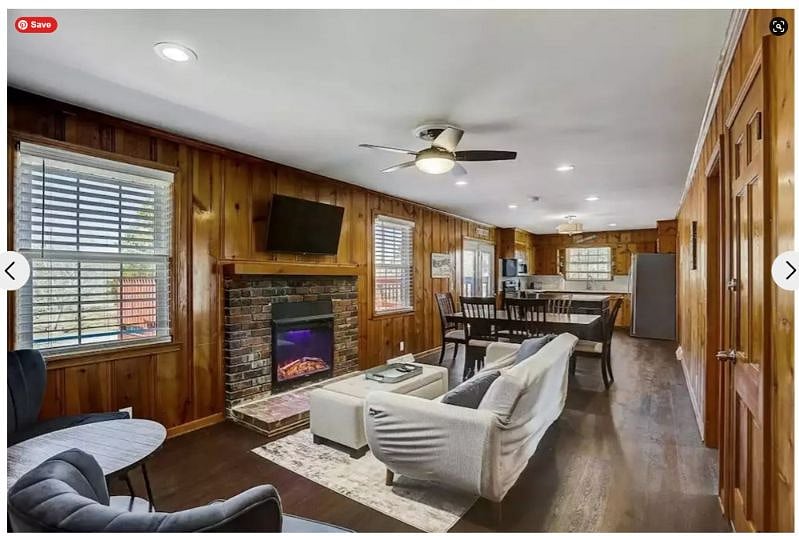 This is the rear living area which includes a futon, chairs, a coffee table and TV