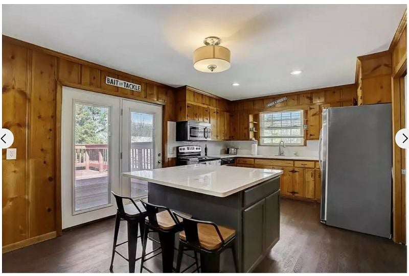 Another shot showing the full kitchen with microwave, full size refrigerator/freezer, dishwasher stove/oven