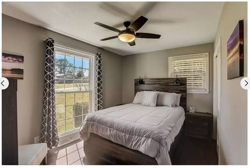 Bedroom 2 provides a queen bed, an armoir, two charging nightstands and an ample closet