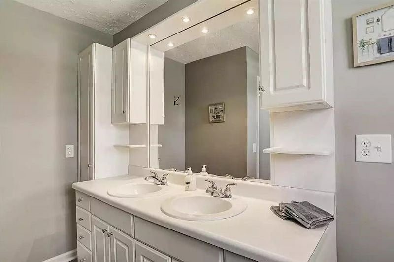 The hall bath has plenty of storage and counter space