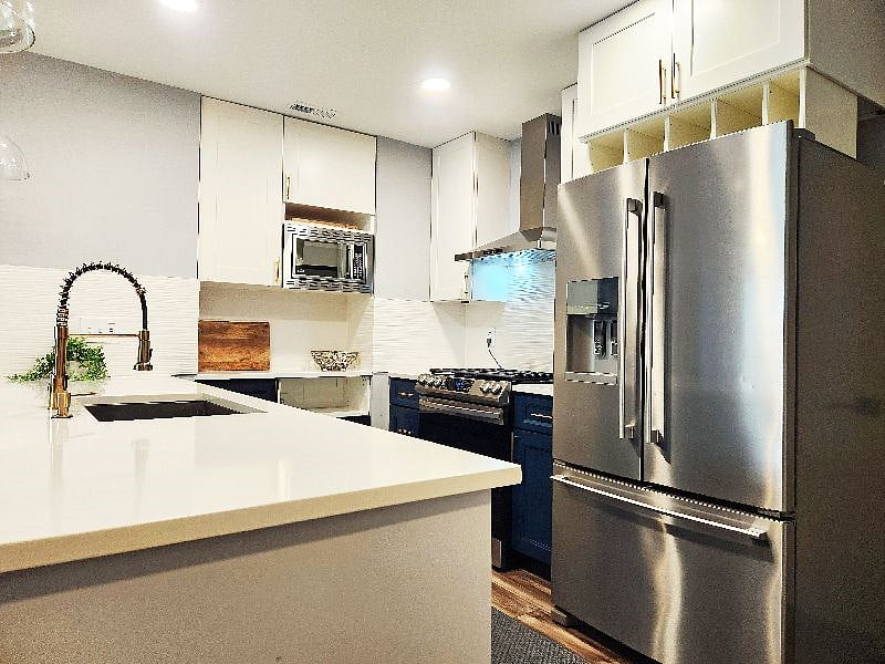 Full size refrigerator with freezer on the bottom, ice maker and filtered water dispenser.