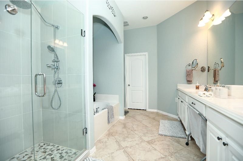 Spacious master bathroom with double sinks and large closet