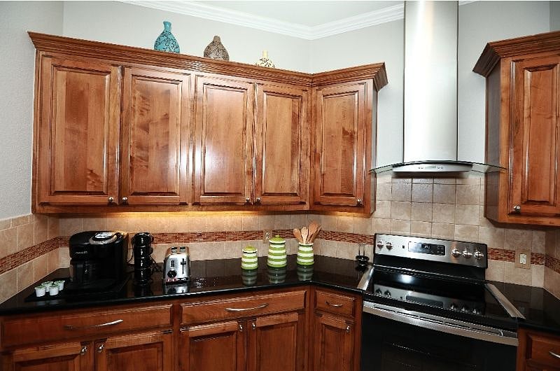 Well equipped kitchen with Keurig coffee maker, toaster, and stove with convectional oven