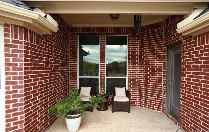 Covered patio with view to the community lake in the backyard