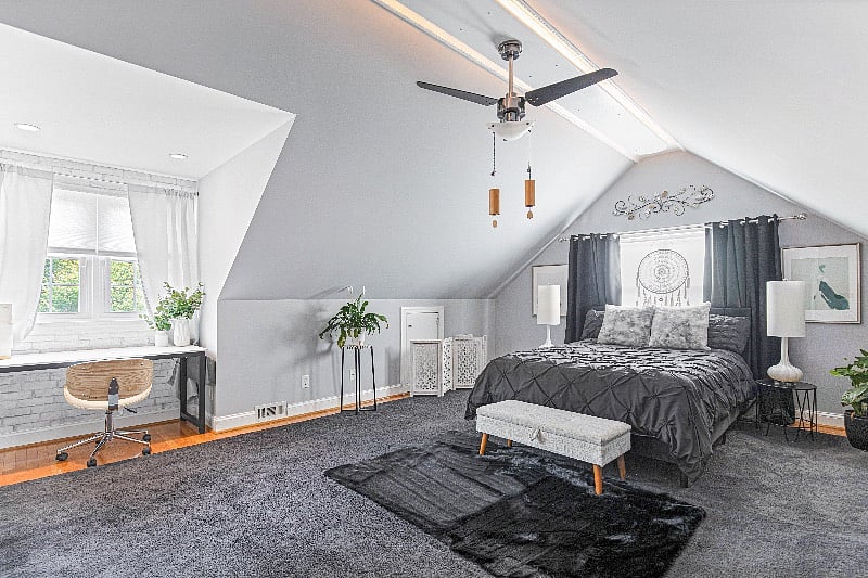 The upstairs Master Suite offers a dedicated workspace, walk-in closet and attached private bathroom.