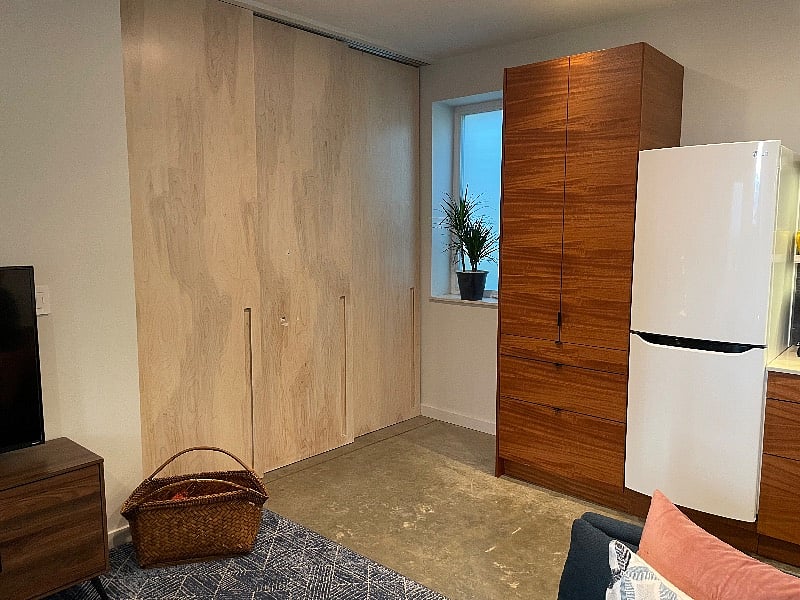 View of the main living area and custom sliding doors that can be opened to allow for more living/work space or closed for privacy/second bedroom feel.