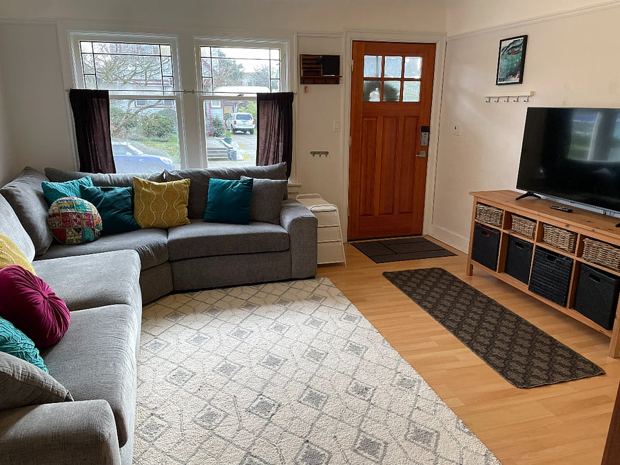 Living room with giant comfortable couch and tv with streaming