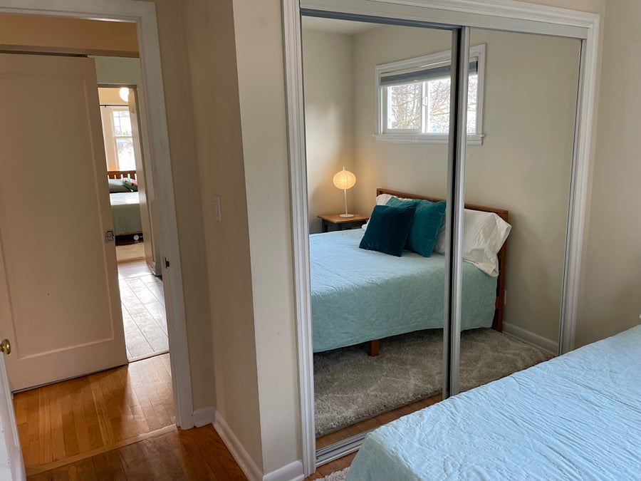 View from bedroom 2 showing large (mirrored) closet and entry into bathroom